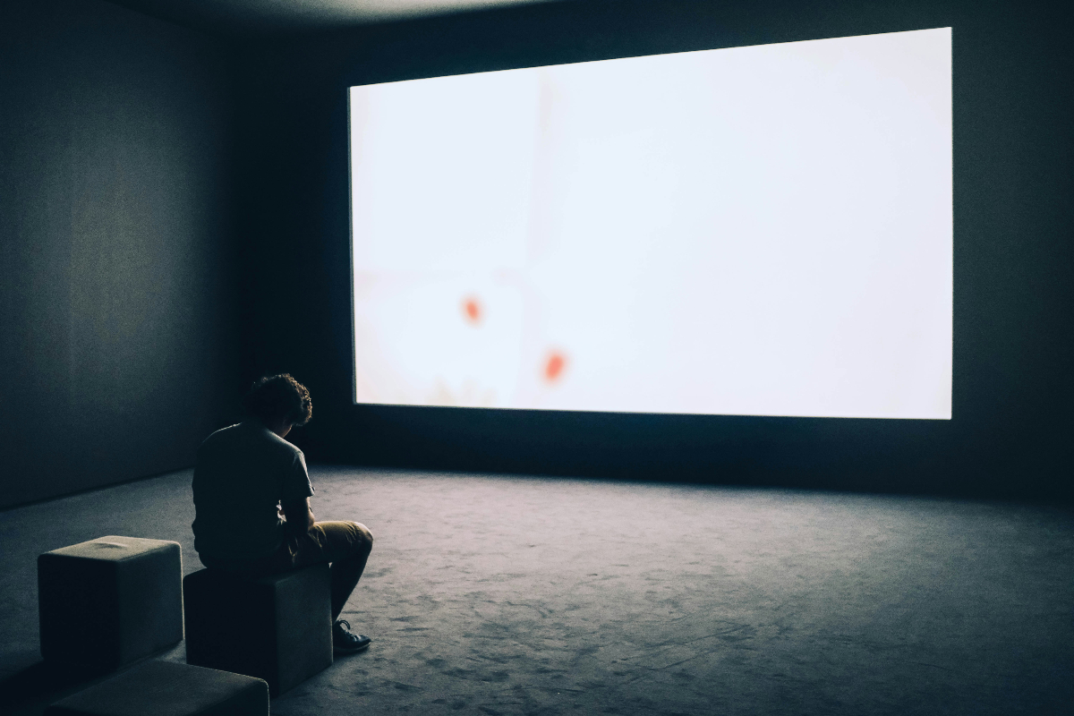 Just a man sitting in an exposition.